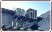 Two AC units installed on upper wall of building just under the roof edge Central Kentucky